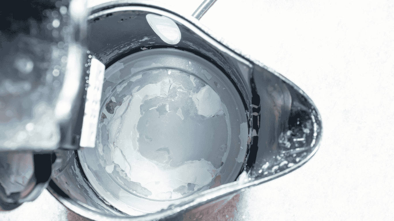 This image explains what is hard water by visually demonstrating water hardness caused by high levels of calcium carbonate. The cloudy residue and buildup represent calcium deposits commonly found in household sinks when mineral concentrations are high, typically measured in mg l. In many homes, salt is used in water softening systems to reduce these mineral deposits and manage hard water problems.